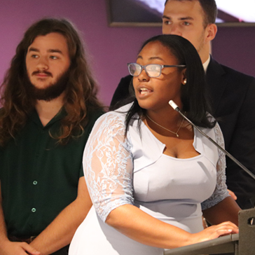 Team member explains weather app at presentation event