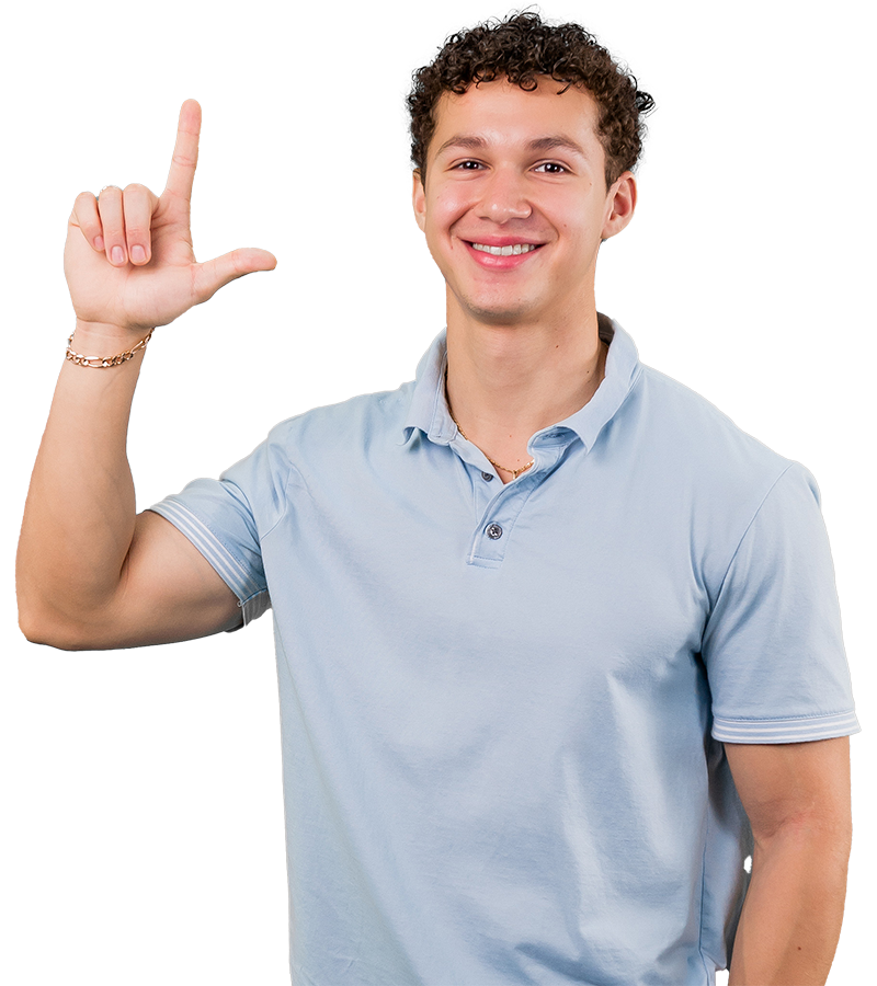 Fernando Carcamo Soler wears a blue polo and smiles as he holds his hand in the shape of an L