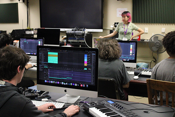 Student participating in a sound engineering summer camp