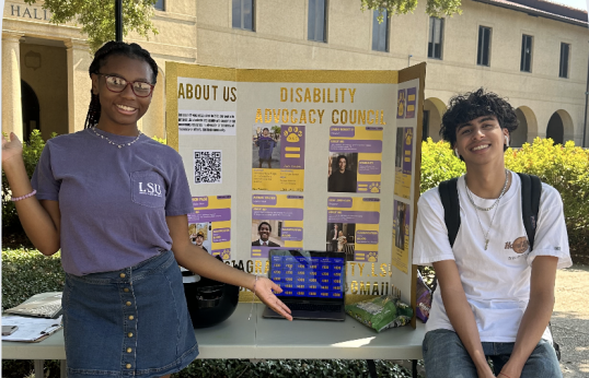 DAC students at a table sit