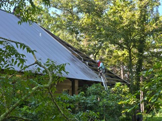 construction workers replacing roof