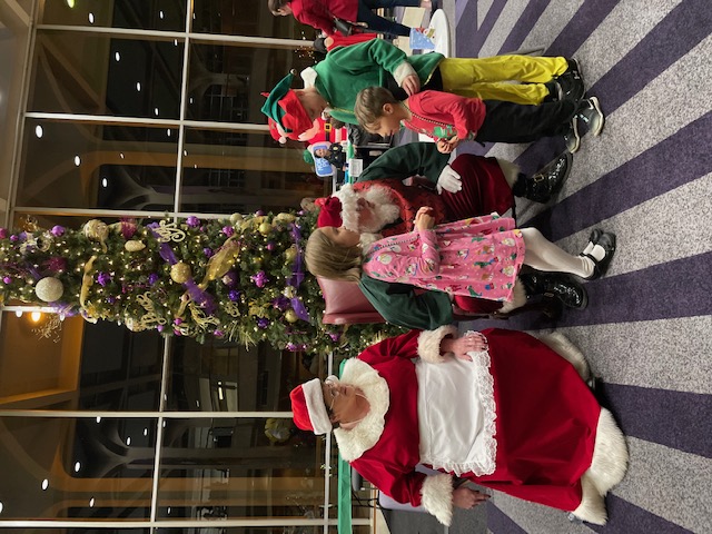 Santa Claus and Mrs. Claus with children
