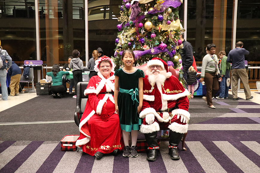 child with Santa and Mrs. Claus